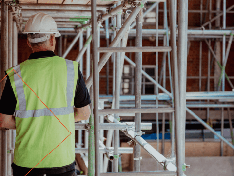 Man met veiligheidshelm in bouw